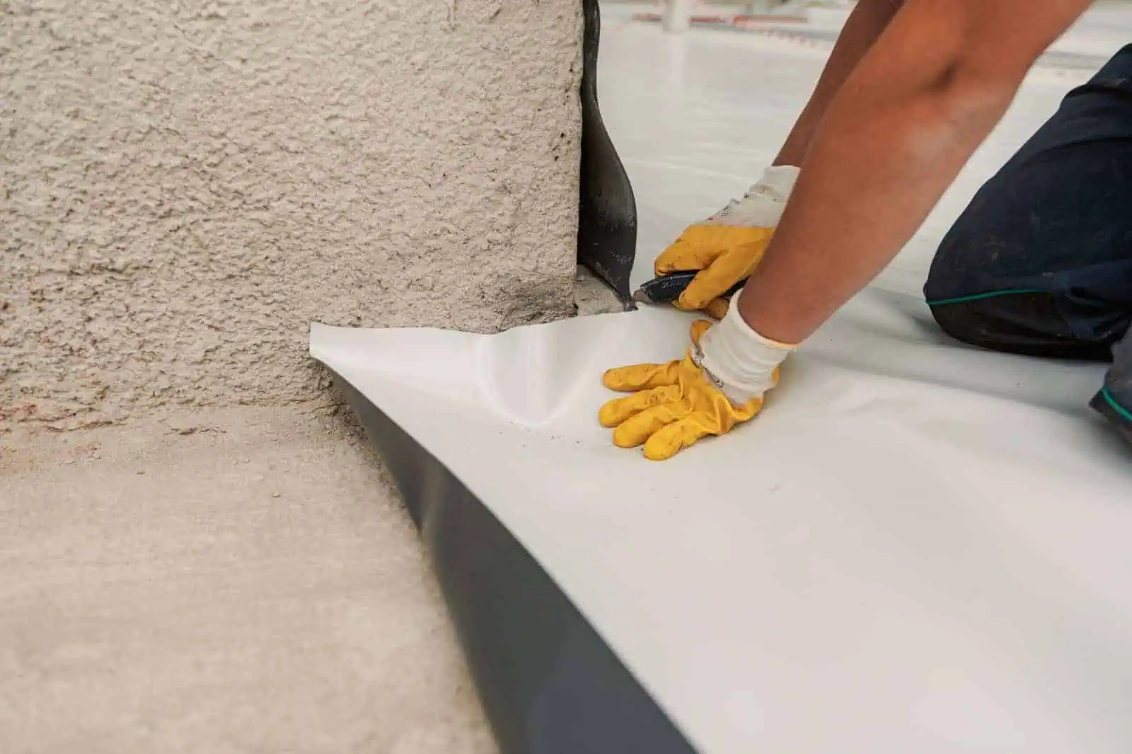 Worker applying insulation to wall for soundproofing and thermal efficiency.