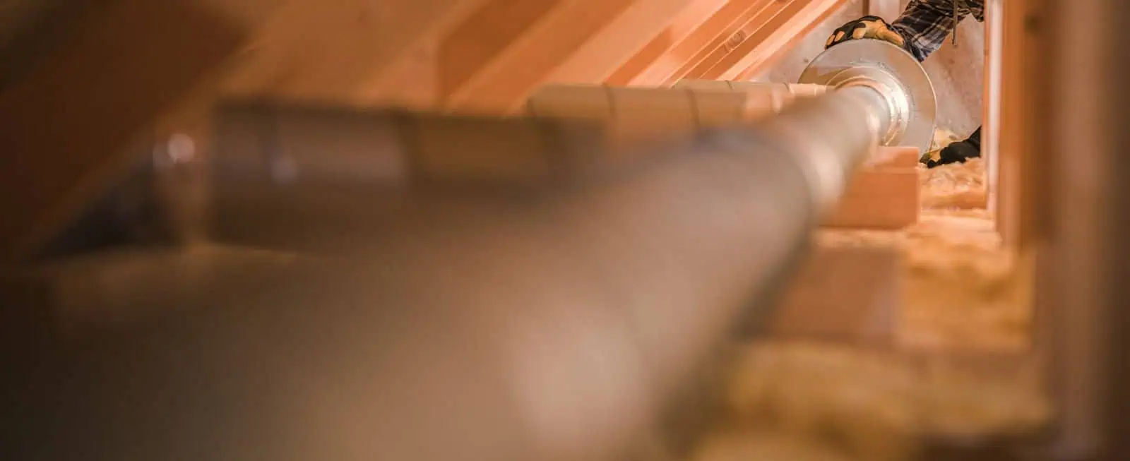 Close-up of insulation pipe in a wooden wall for soundproofing and thermal insulation.
